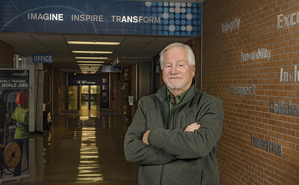 Gary Bayens posing in a hallway at Washburn Tech
