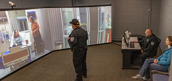 An officer interacts with the criminal justice simulator
