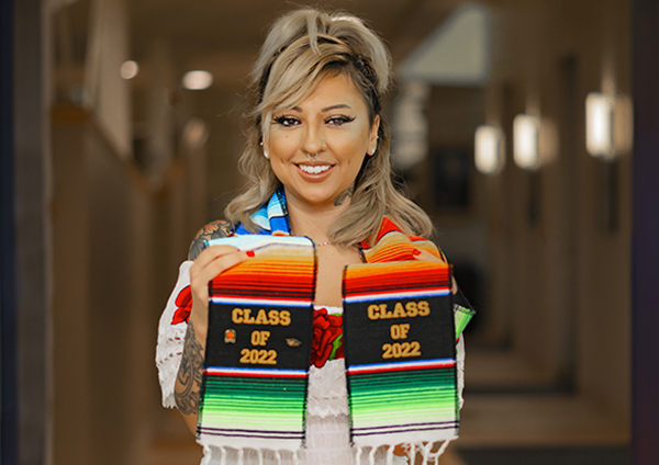 Deyjah Cardenas posing with her graduation shawl