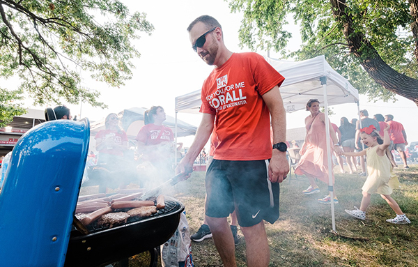 Daniel Creitz standing over a bbq grill during a picnic