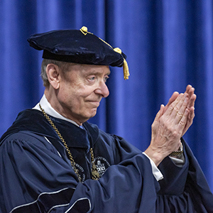 Jerry Farley at commencement clapping