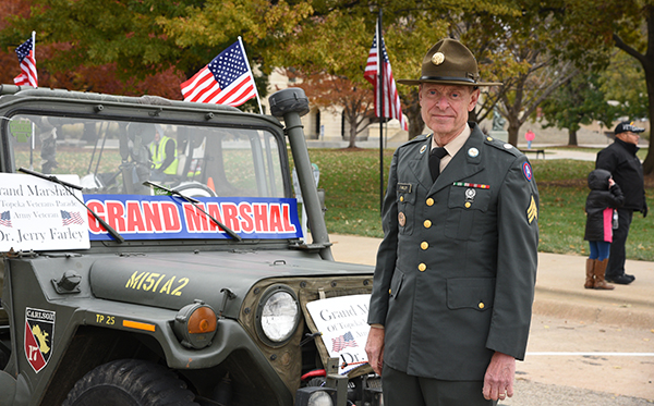 Dr. Farley posing in his Army uniform at a parade