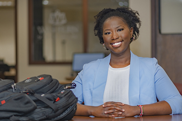 Elizabeth Ngatia poses in the Washburn Law library