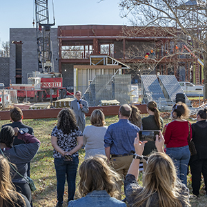 Jerry Farley speaks in front of the school of law construction site