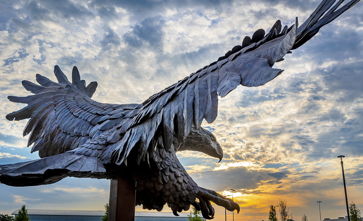 The eagle sculpture with the sunset in the background