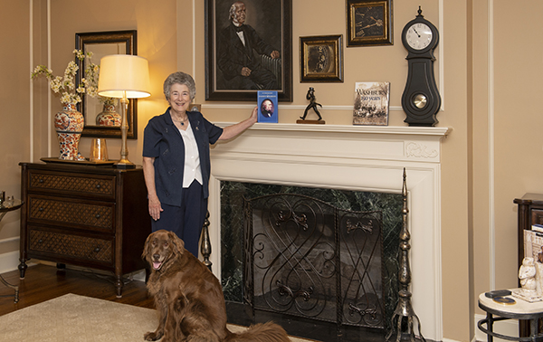 Susan Farley and her dog, Hershey, posing in the presidential residence