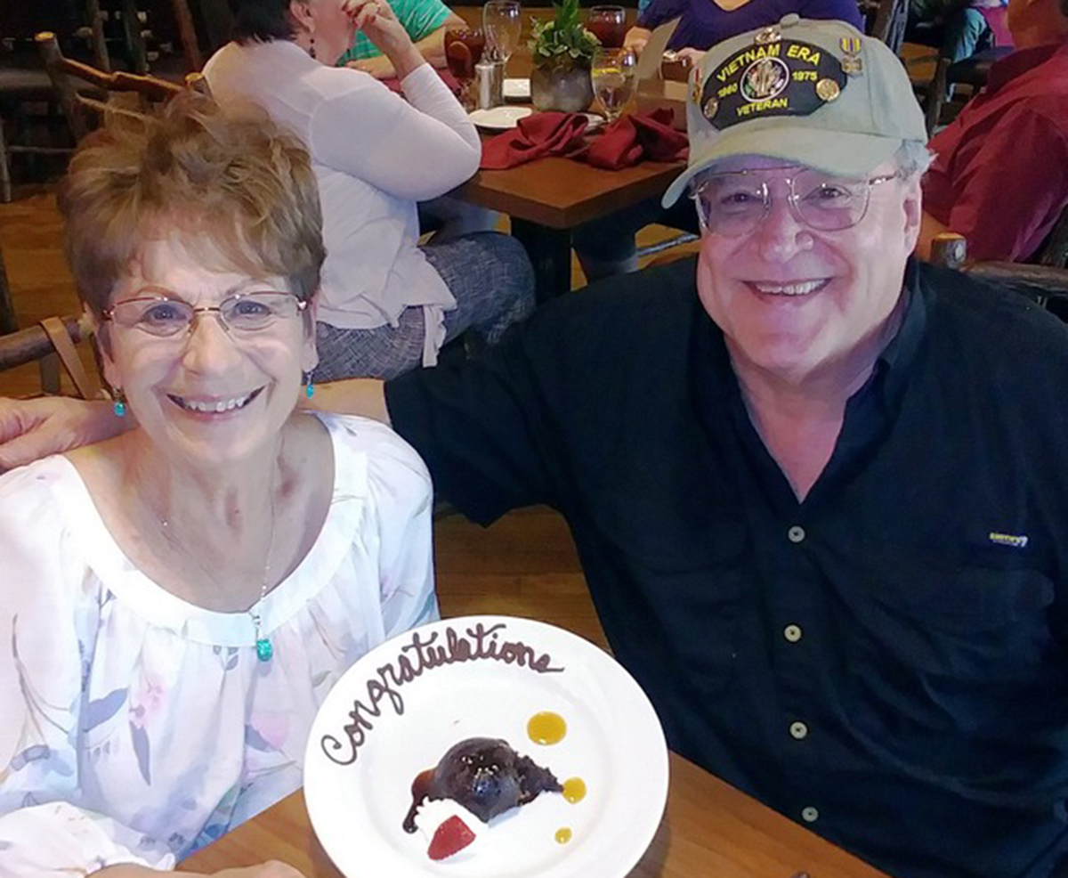 Jim Webber and his wife celebrate their anniversary with a piece of cake
