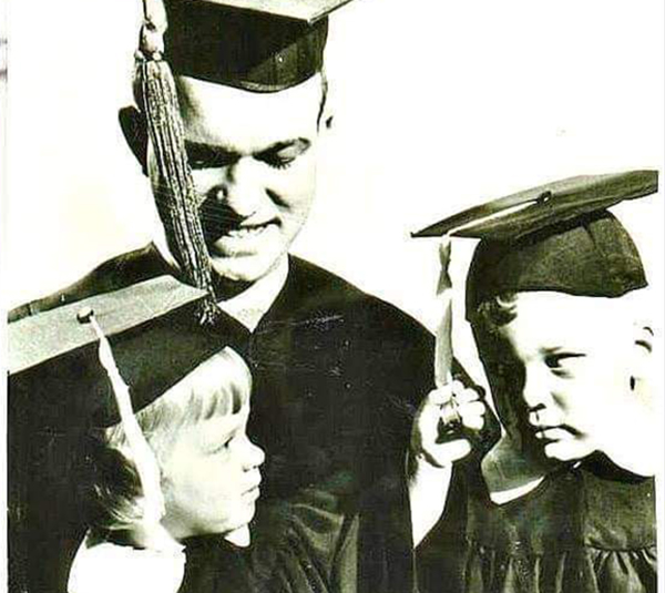 An old photo of Dennis White and his sister as children, celebrating with their father, Merlin White at his Washburn graduation