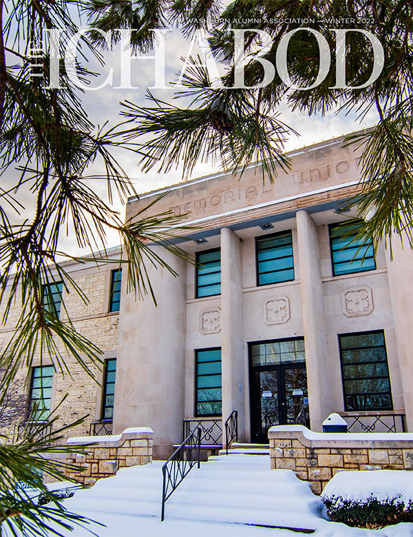 The Ichabod Magazine Winter 2022 cover - Memorial Union with snow, pine needles in the foreground
